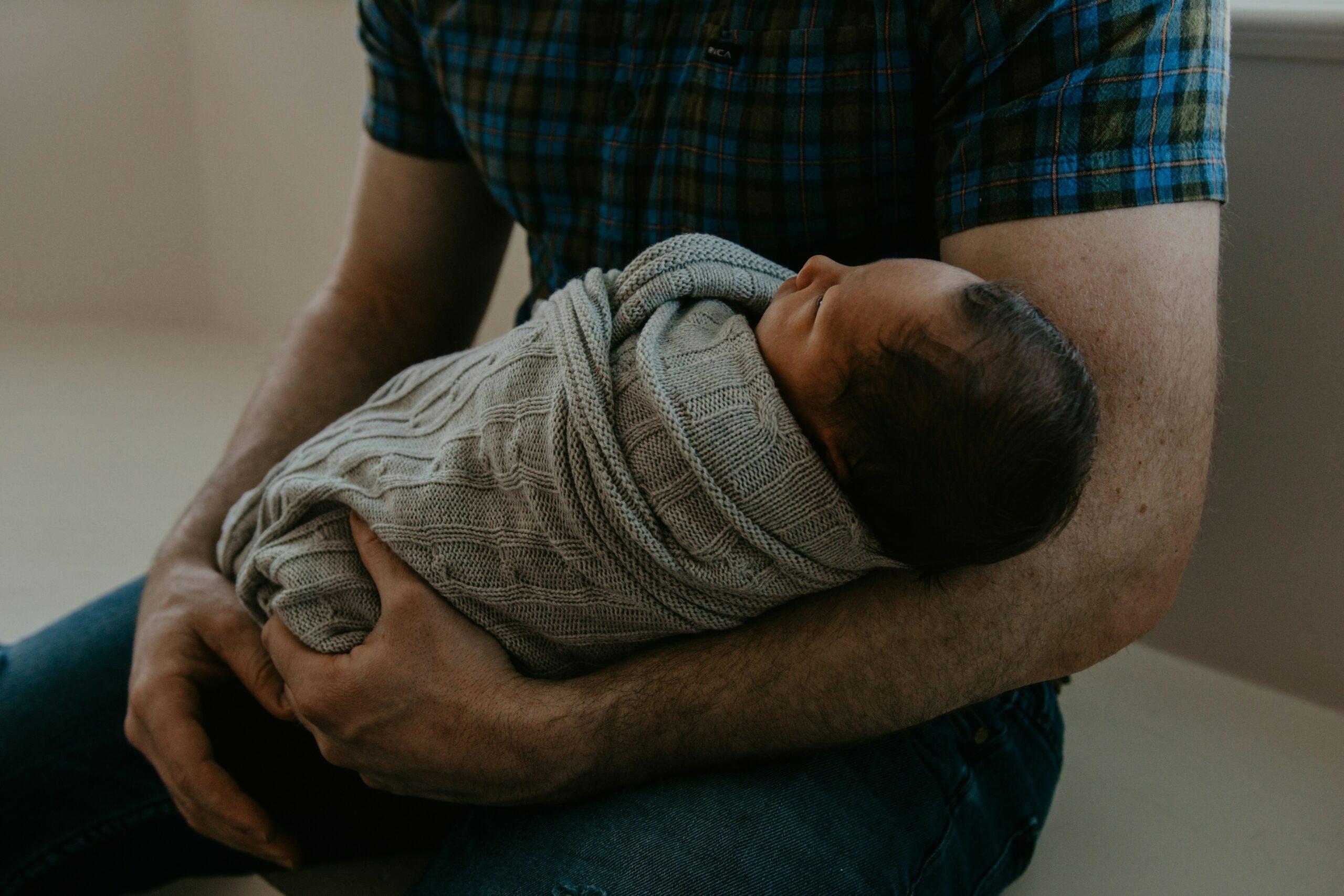 father with a newborn baby
