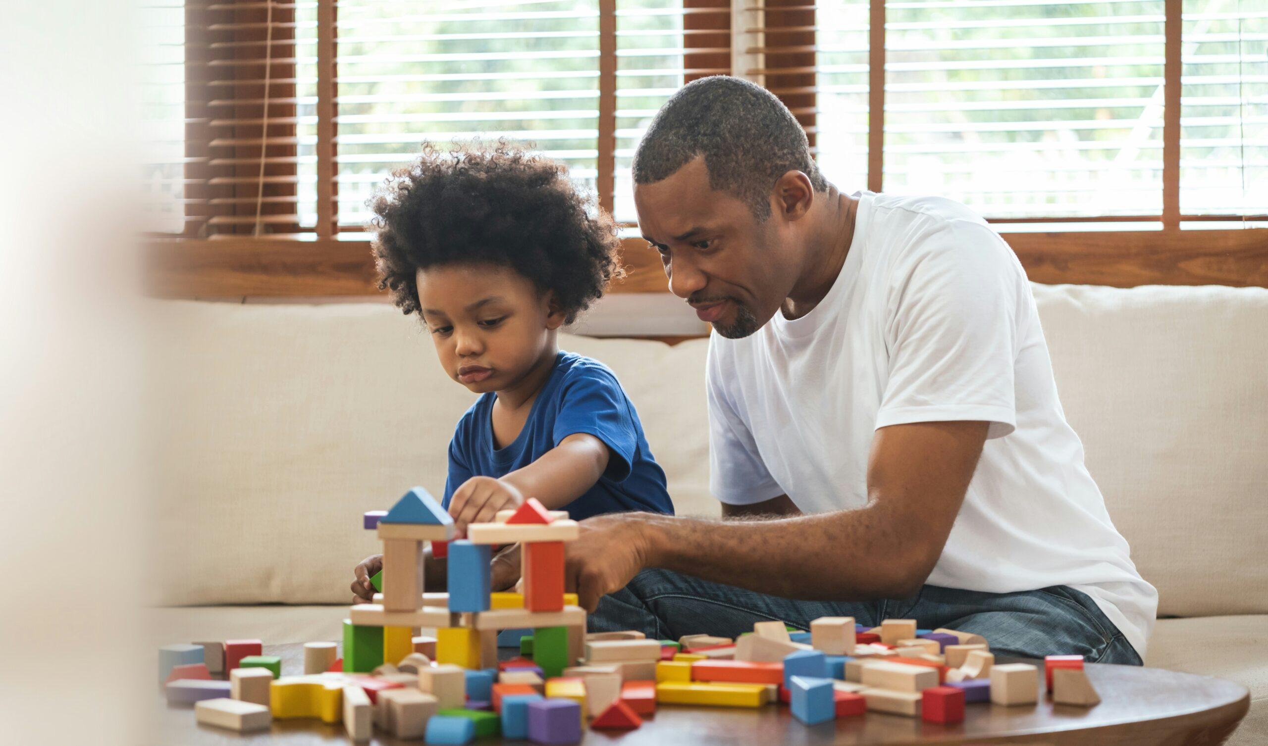 father playing with child with toys